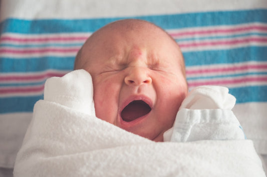 Sweet newborn baby yawning