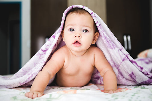 Baby resting comfortably under blanket